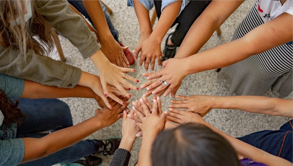 diverse group of people collaborating around a central hub of ideas - ai prompts for marketing